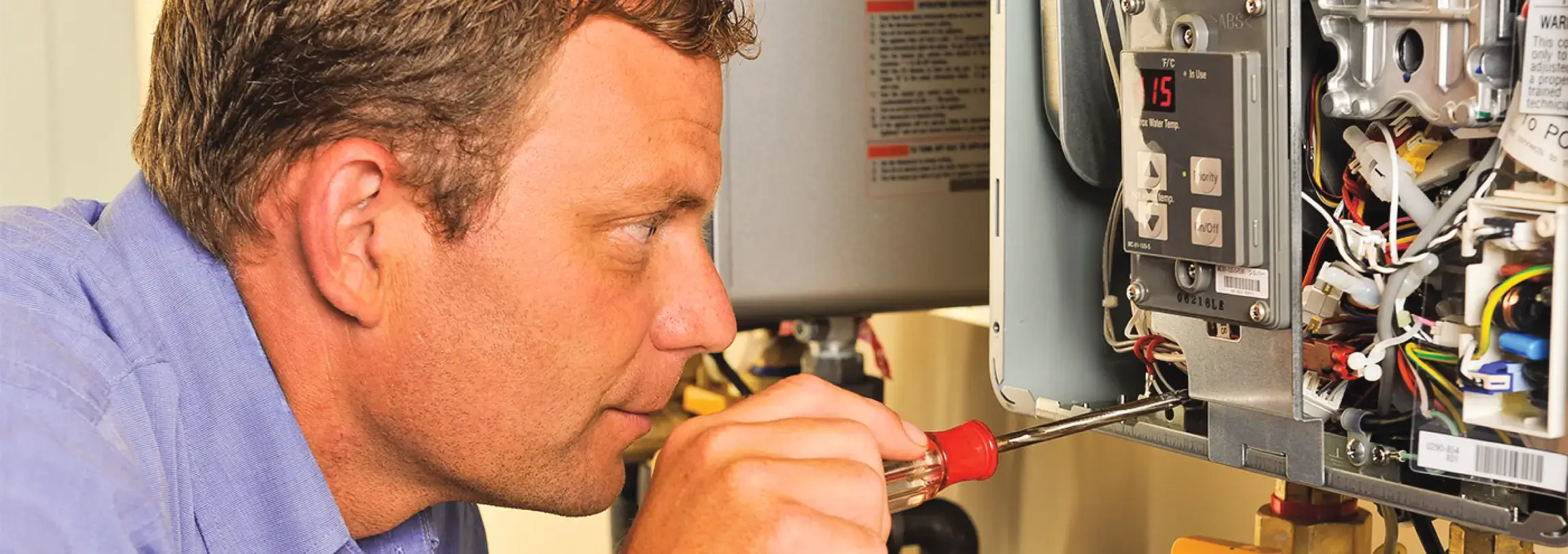 Service tech working on water heater
