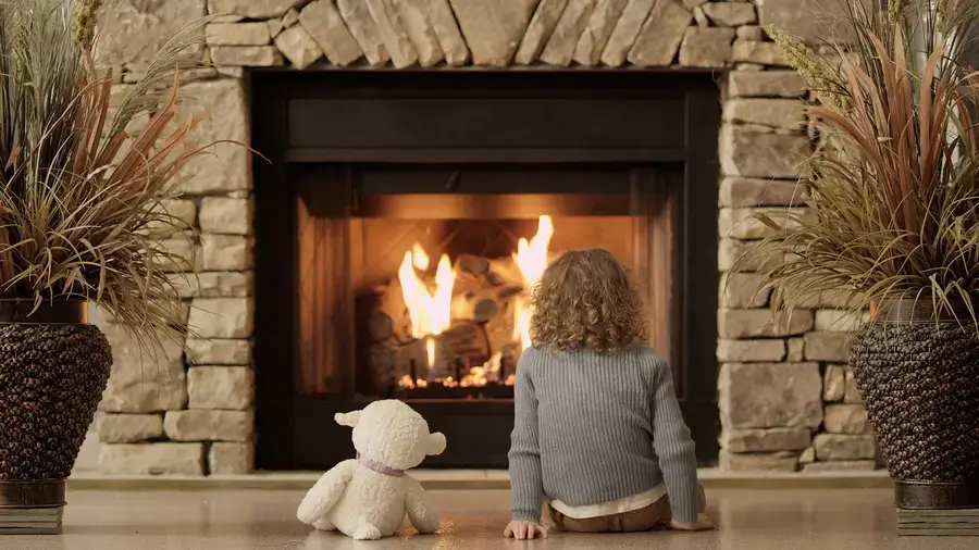 http://Small%20girl%20and%20toy%20bear%20enjoying%20a%20fireplace.