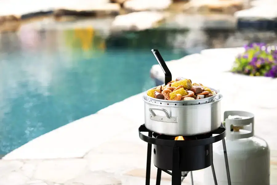 http://Shrimp%20boil%20with%20propane%20cooker%20by%20pool%20side.