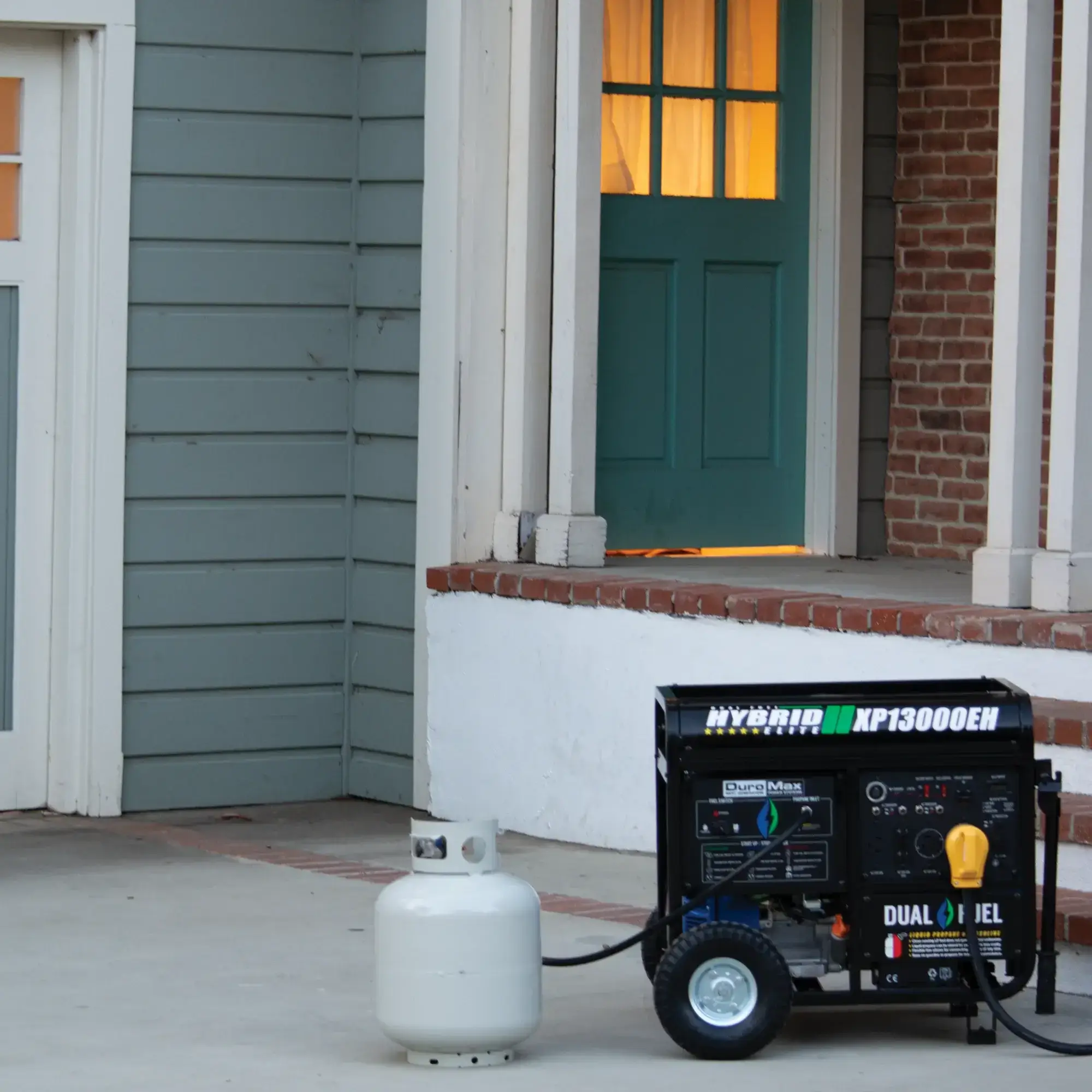 DuroMax XP13000EH in driveway next to front porch