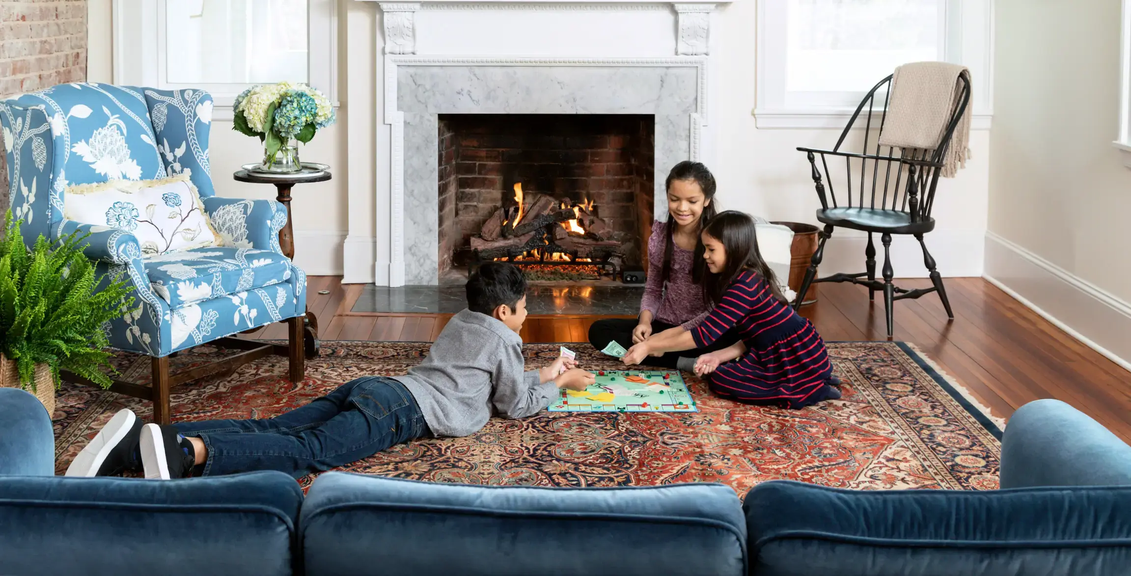 Children in living playing in front of fireplace