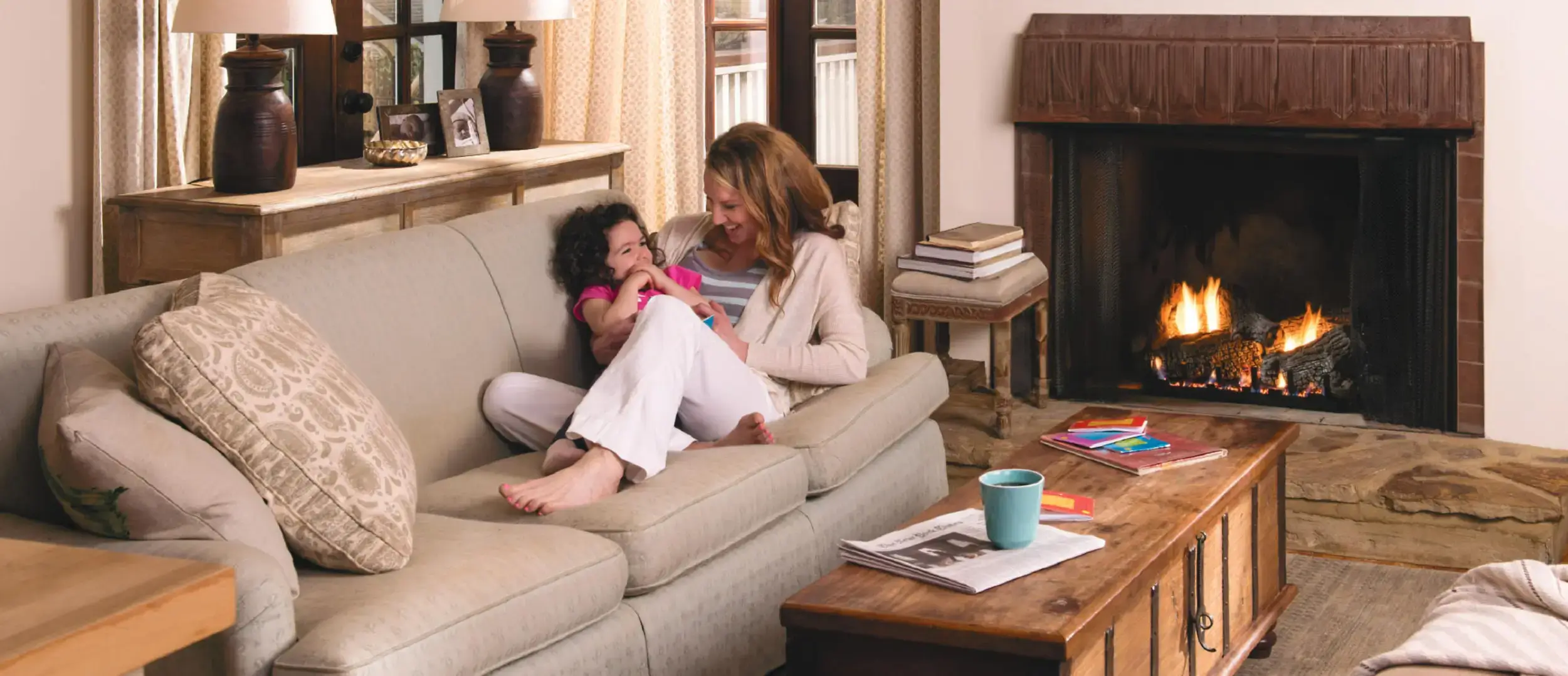 Mother and child by fireplace