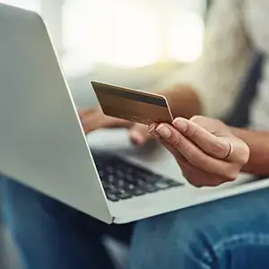 Woman Paying Bill On Laptop With Credit Card